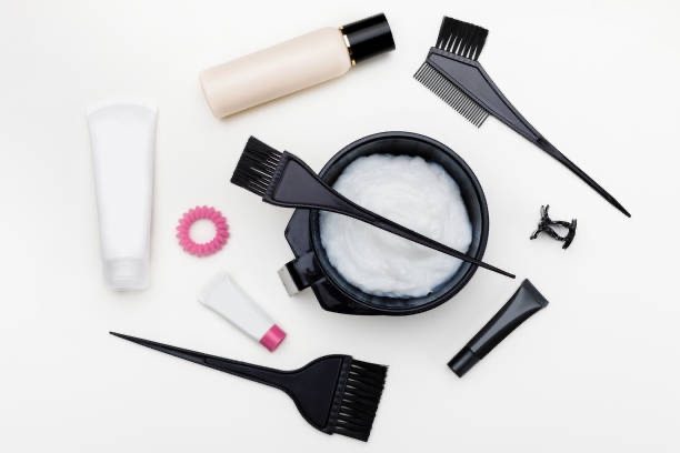 Can You Dye Wet Hair? | Expert Advice For Every Hair Type. 2 Tools for keratin treatment. brush, bowl and hair dye in tubes top view