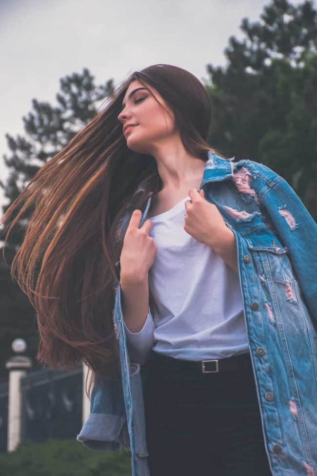 woman thinks about difference between semi-permanent and permanent hair dye