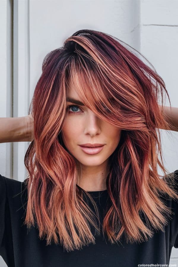 The Best Hair Colors To Make Blue Eyes Really Pop 11 woman with dark copper red hair and blue eyes