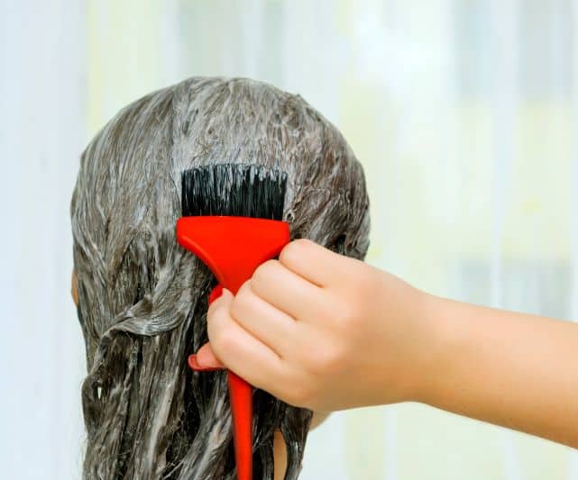 Is Color Oops and Bleach Safe to Use on the Same Day? | A Guide for DIYers 2 color oops and bleach same day - lady applying color oops in hair