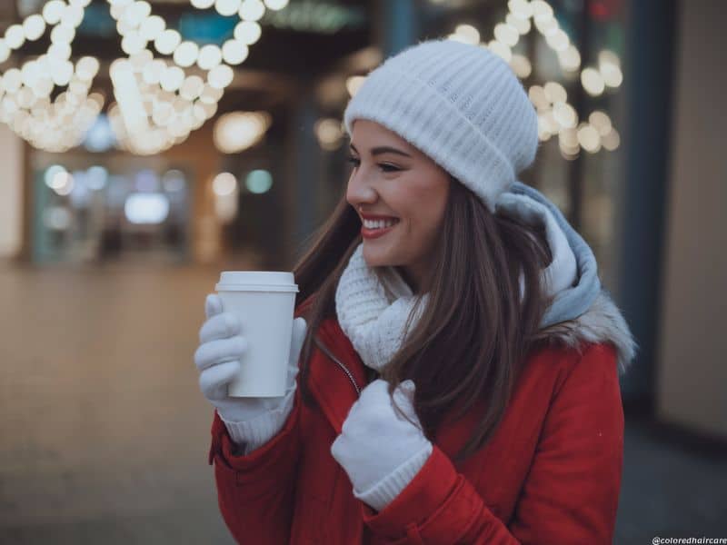 How to Keep Your Hair Happy This Winter – 7 Expert Tips for Every Hair Type 3 winter hair color protection - woman with dyed hair wearing a woolly hat