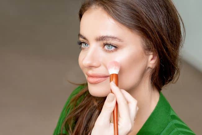 How to Choose the Right Hair Color for You - Easy Step-by-Step Guide. 2 Know your skin undertones - a women applying make up that suits her undertones