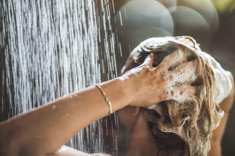 woman washing her hair in the shower