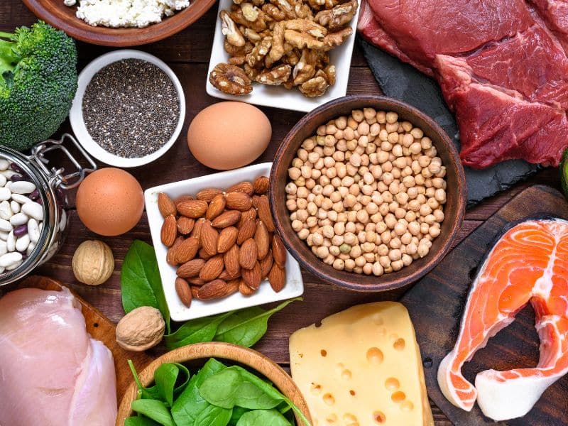 Show an image of healthy, nutritious foods like spinach, nuts, and lean meats, symbolizing the dietary remedies that can help with hair loss.