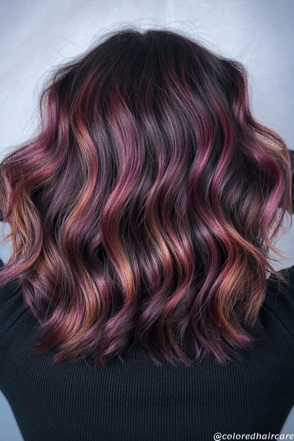 25 Balayage Ideas for Black Hair That Actually Pop (2025 Looks & Tips) 21 Sunset sangria balayage with red, orange, and pink tones on black hair