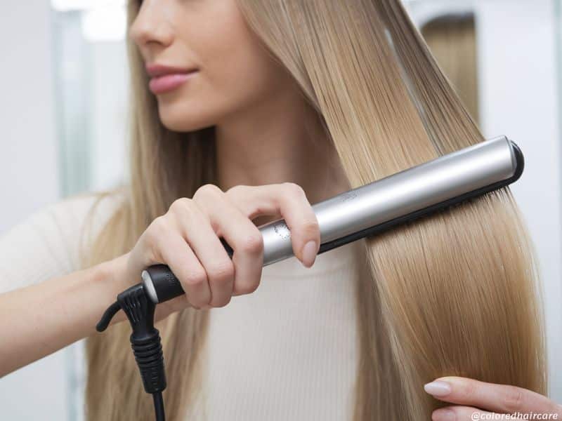 How to Get Amal Clooney’s Signature Waves Without Any Heat Damage 4 a woman using a hair straightener flat iron