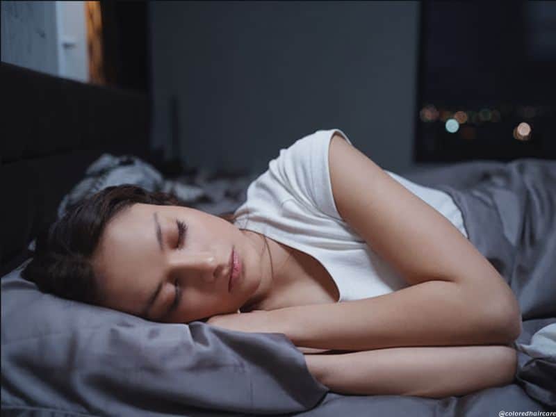 woman lying on a silk pillowcase